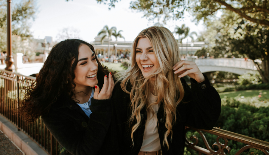 Two women laughing together outdoors